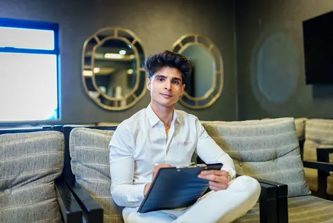 Dr Nikhil Maharaj, founder of Aurelia Private Health, smiling in the practice lounge